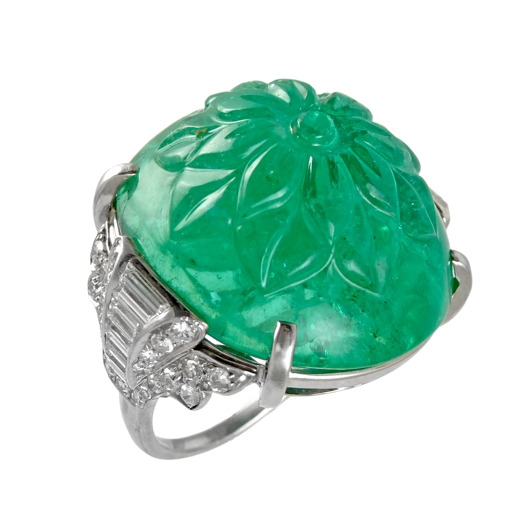 Art Deco carved emerald cabochon and diamond ring by Mauboussin, with large dome shaped floral carved Colombian emerald of 50.87ct, probably Indian carved,
